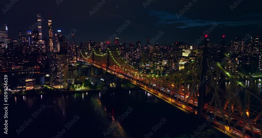 Wonderful Queensboro Bridge lit in green and orange. New York scenery full of lights at night time. Top view. Wonderful Queensboro Bridge lit in green and orange. New York scenery full of lights at night time. Top view.