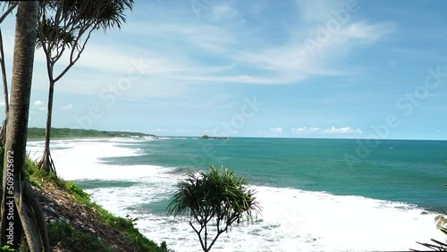 View of the ocean waves on the Karang Tawulan beach, Indonesia photo