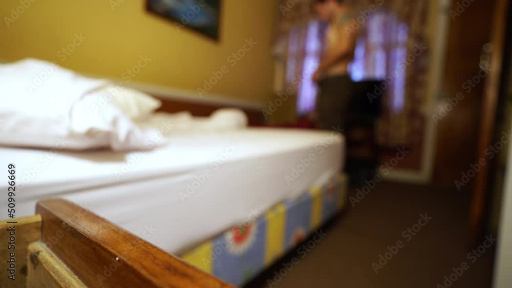 Young athletic caucasian traveller male getting ready in the morning for backpacking travel in a hostel room Young athletic caucasian traveller male getting ready in the morning for backpacking travel in a hostel room