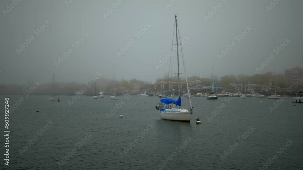 Yachts and sailboats in the bay at anchor. Beautiful foggy morning. High-quality 4k footage Yachts and sailboats in the bay at anchor. Beautiful foggy morning. High-quality 4k footage