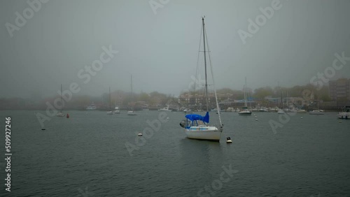 Yachts and sailboats in the bay at anchor. Beautiful foggy morning. High-quality 4k footage