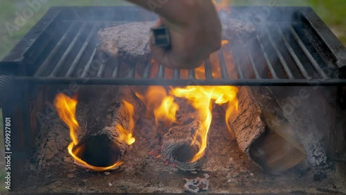 Man cooking meat steaks on a professional grill outdoors. High-quality 4k footage