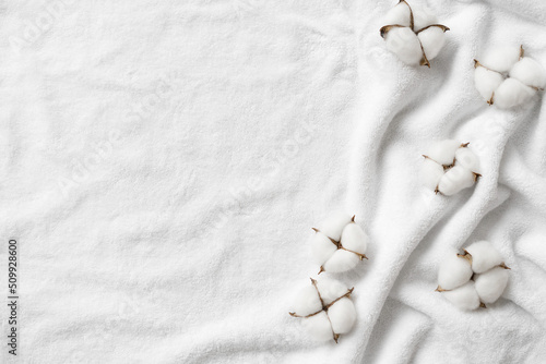 Cotton balls on a white terry towel with copy space.