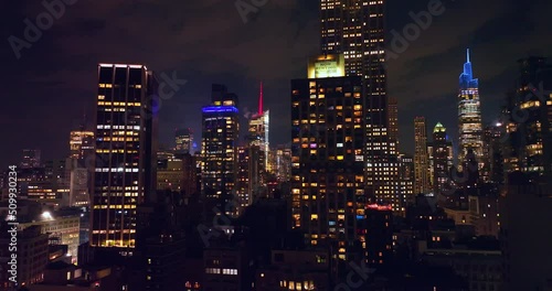 Wallpaper Mural Fantastic skyscrapers with lights in windows. Wonderful buildings at the backdrop of night cloudy sky. Torontodigital.ca