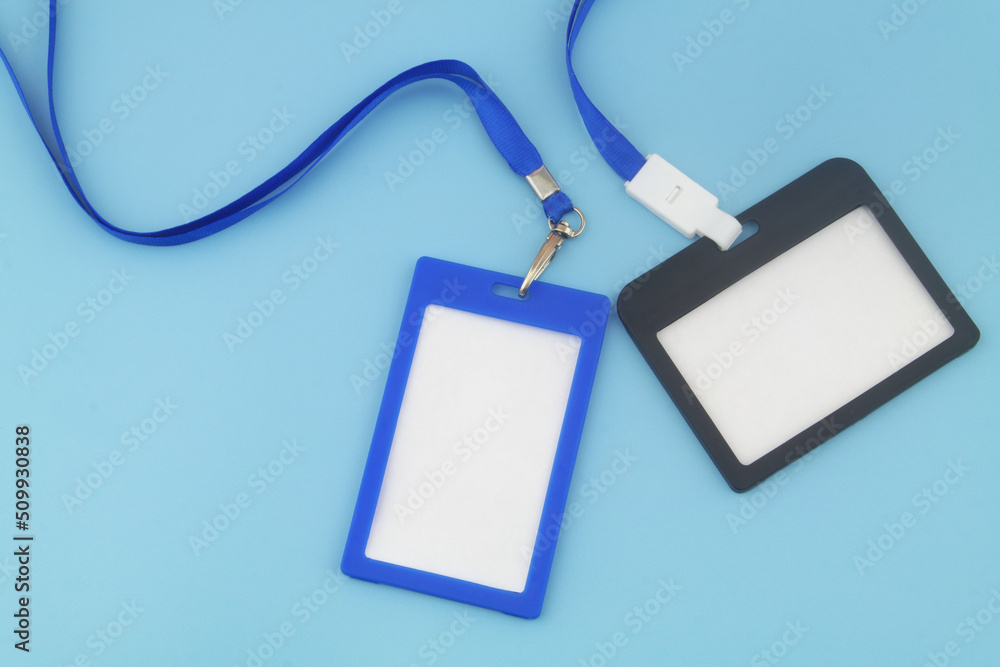Blue and black blank plastic badges with space for text on blue background. Blue and black blank plastic badges with space for text on blue background.