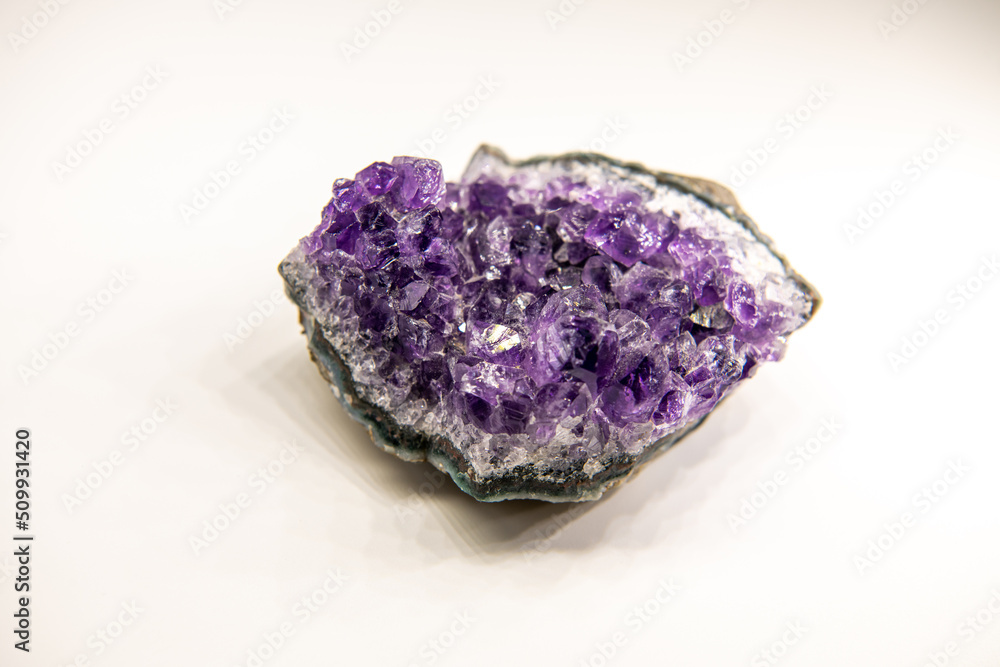 Amethyst geode on the white background, purple gemstone, horizontal close up shot, background