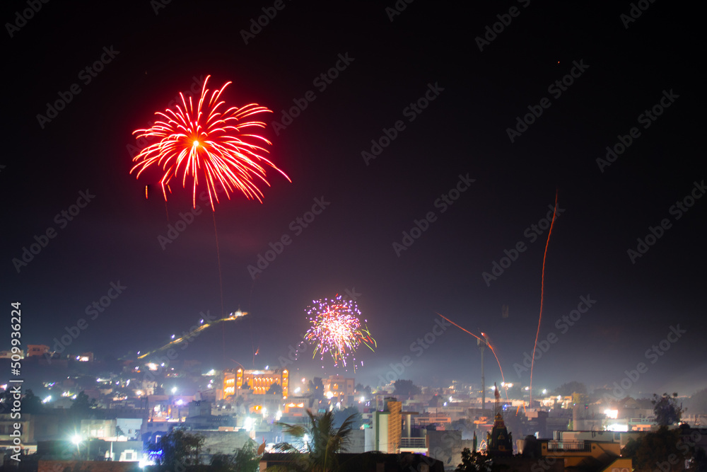 Wide angle shot of fireworks above the city during the new year festival in India. Celebration background. Fireworks in the sky above the city, Celebration background. Background of city with firework