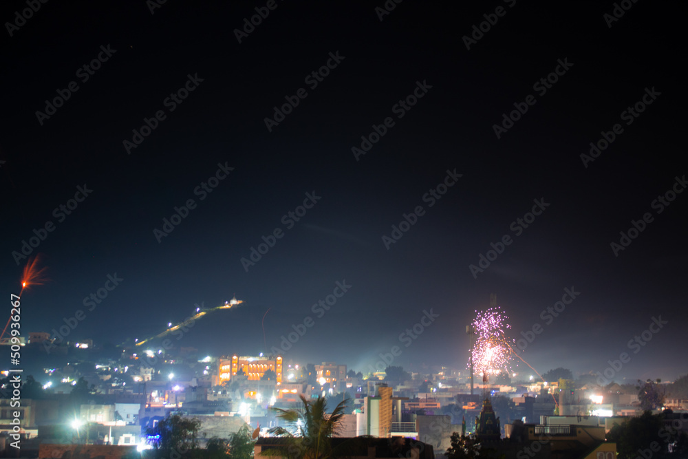 Wide angle shot of fireworks above the city during the new year festival in India. Celebration background. Fireworks in the sky above the city, Celebration background. Background of city with firework