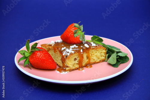 piece of cake with white fondant and red strawberry. on the plate. Confectionery, cakes. food. sweet concept.
