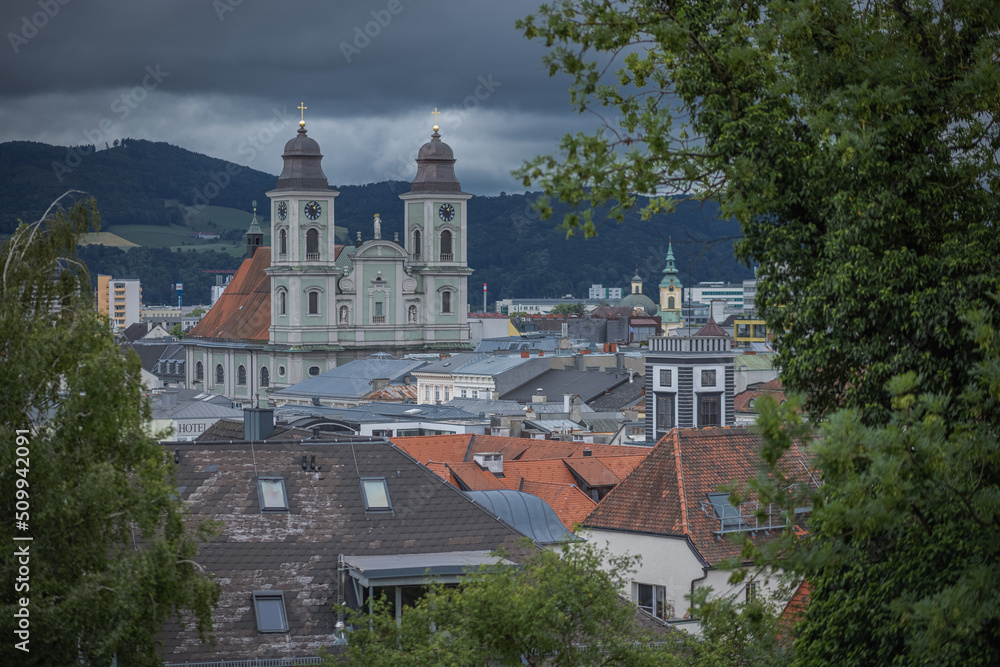 Green church with twin towers in Linz, Upper Austria, Skyline of Linz with old twin tower church as vantage point.