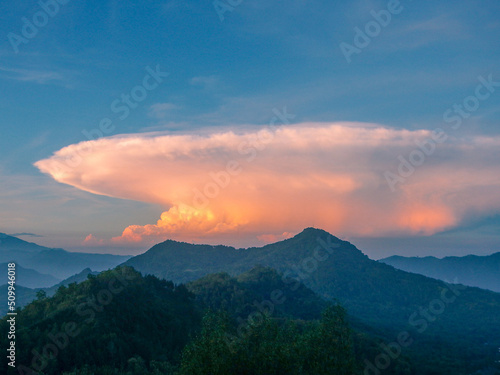 sunset over the mountains with blue sky and orange cloud