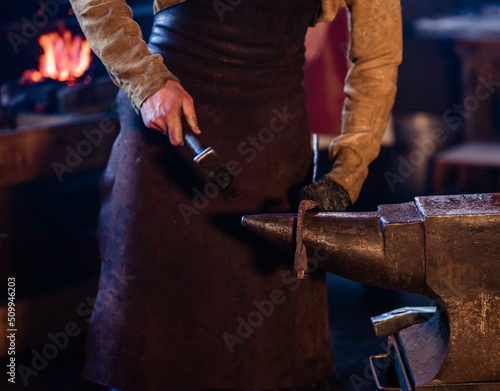 blacksmith makes a product from iron in the forge