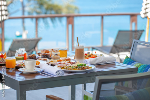 Breakfast in tropical hotel with sea view. Buffet food in restaurant in modern resort. Concept of travel and summer vacation.