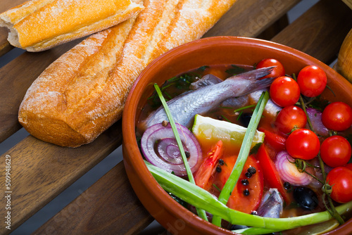 Fisherman's hoosh boiled with poutassou, small sea fish, tomatoes and onion photo