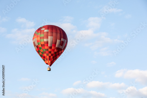 Colorful hot air balloon flies in the sky in good weather