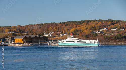 Norwegian coastal landscape with fast ferry boat