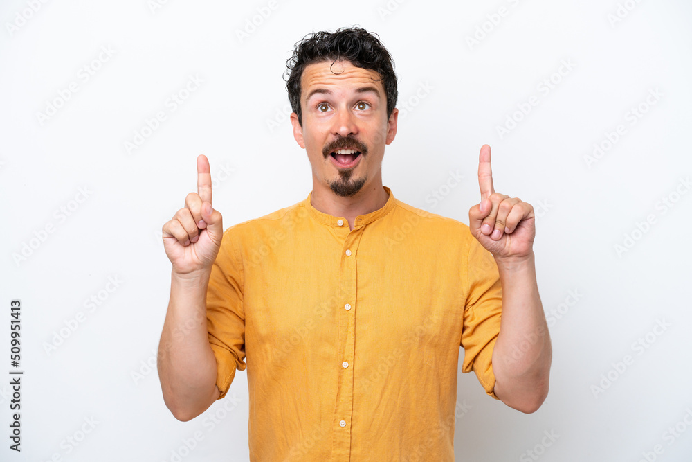 Young man with moustache isolated on white background surprised and pointing up Young man with moustache isolated on white background surprised and pointing up