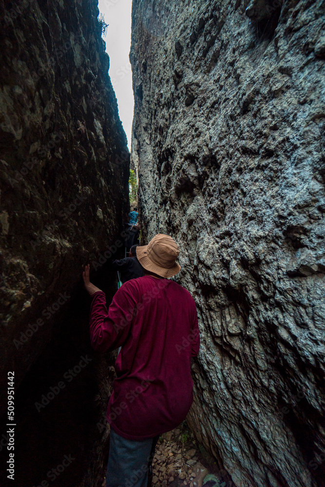One of the hiking trails to the top of the ancient volcano Nglanggeran, Indonesia, there is a narrow passage of 2 large cliffs that must be passed to get to the top One of the hiking trails to the top of the ancient volcano Nglanggeran, Indonesia, there is a narrow passage of 2 large cliffs that must be passed to get to the top