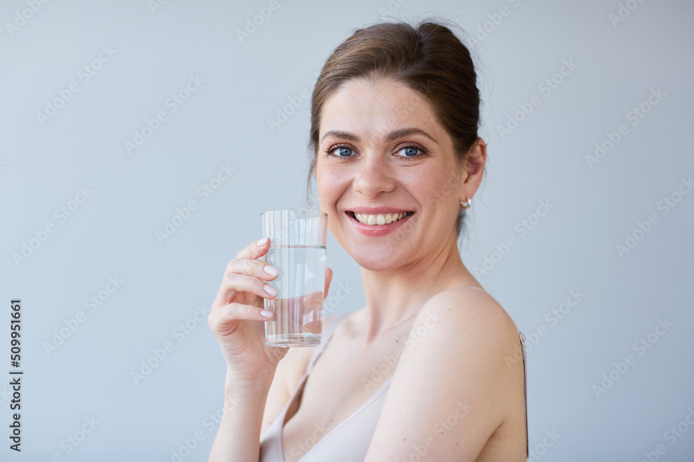 Smile woman drinking water with naked shoulders. isolated portrait. Smile woman drinking water with naked shoulders. isolated portrait.