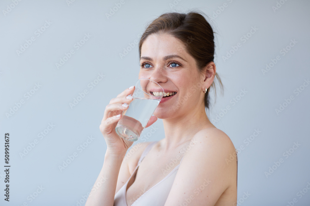 Smile woman drinking water with naked shoulders. isolated portrait. Smile woman drinking water with naked shoulders. isolated portrait.