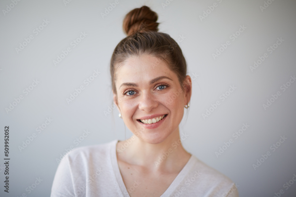 Smiling girl isolated face portrait. Female head shot with shallow depth of field. Smiling girl isolated face portrait. Female head shot with shallow depth of field.