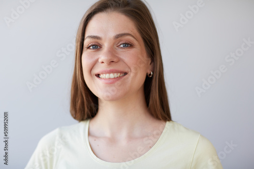 Smiling woman close up face portrait. Female head shot with shallow depth of field.