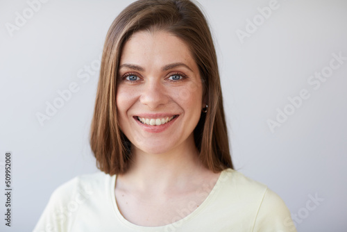 Smiling woman close up face portrait. Female head shot with shallow depth of field. © Yuriy Shevtsov