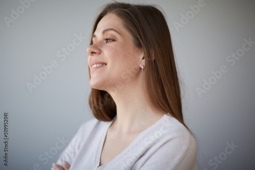 Dreaming woman face portrait. Girl looking away. Female head shot with shallow depth of field.