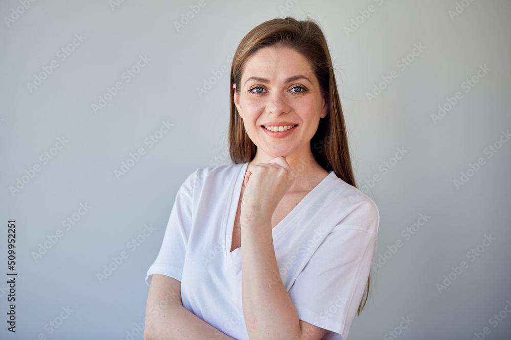 Smiling woman in white shirt touching her chin. Smiling woman in white shirt touching her chin.