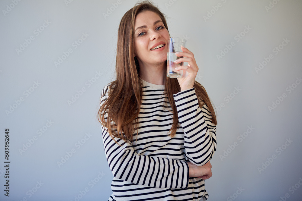 Portrait of smiling woman holding glass with water. Isolated female head shot. Portrait of smiling woman holding glass with water. Isolated female head shot.
