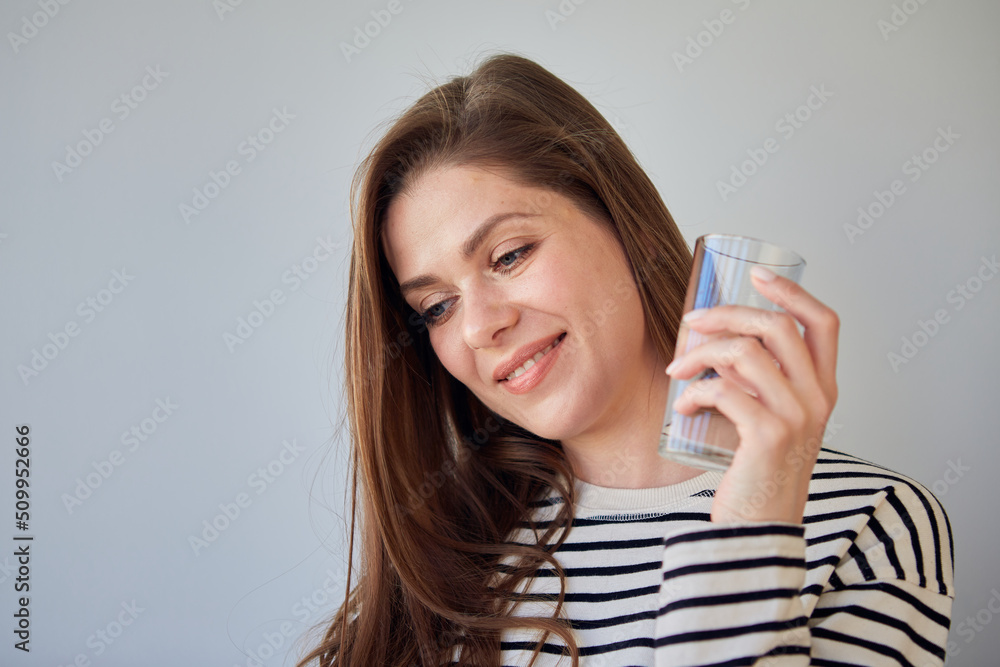 Woman drinking water looking away. isolated portrait happy girl. Woman drinking water looking away. isolated portrait happy girl.