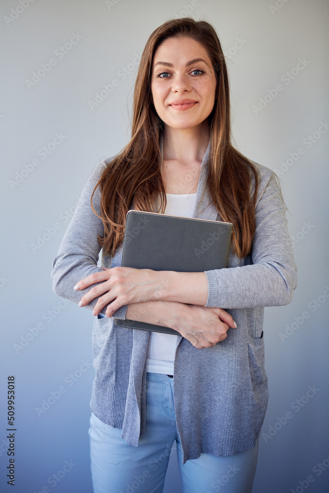 Smiling student girl dressed casual clothes holding book. Woman teacher with long hair. Smiling student girl dressed casual clothes holding book. Woman teacher with long hair.