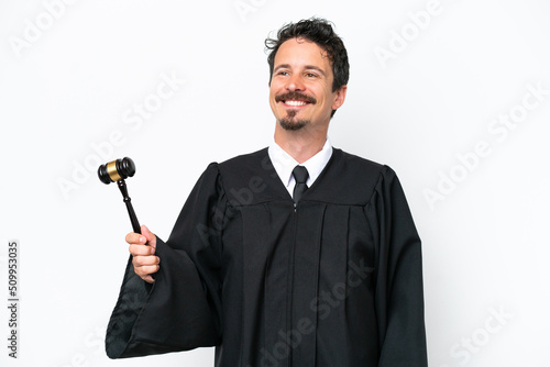Young judge caucasian man isolated on white background thinking an idea while looking up