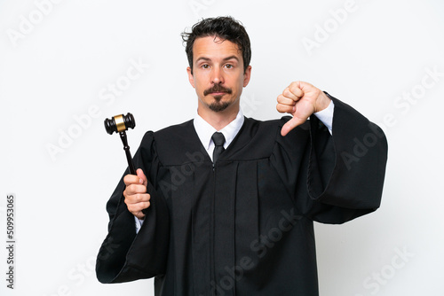 Young judge caucasian man isolated on white background showing thumb down with negative expression