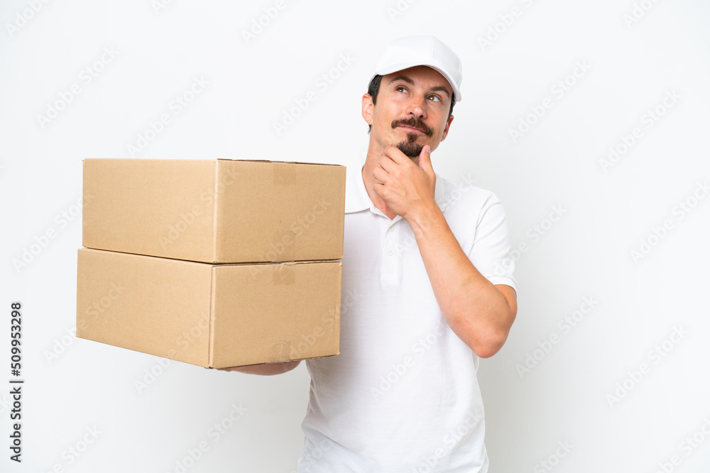 Delivery caucasian man isolated on white background and looking up Delivery caucasian man isolated on white background and looking up