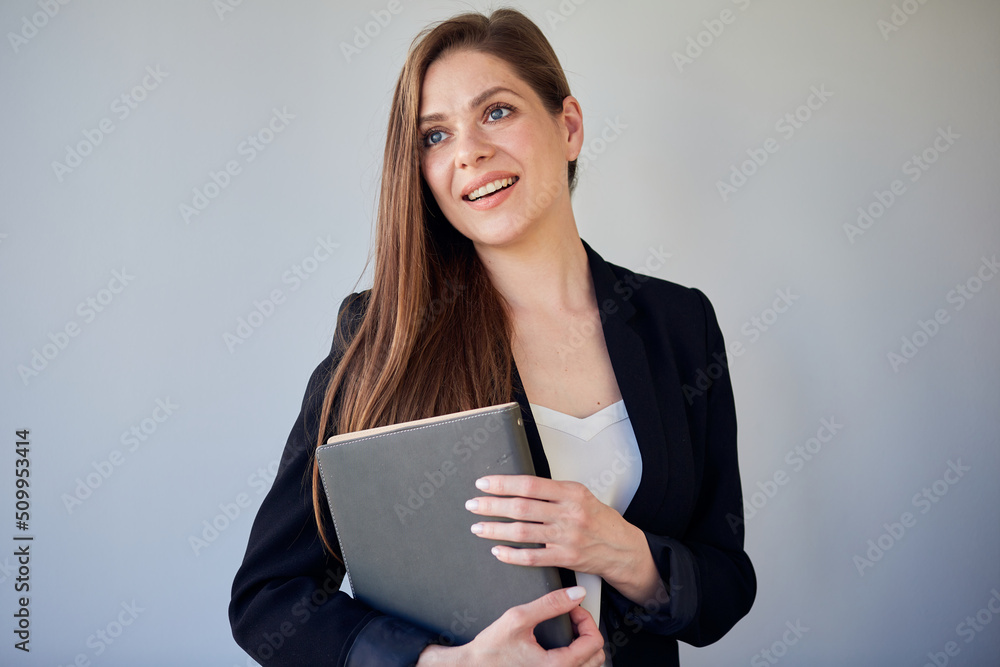 Woman teacher or girl student in black suit holding book looking away. Woman teacher or girl student in black suit holding book looking away.