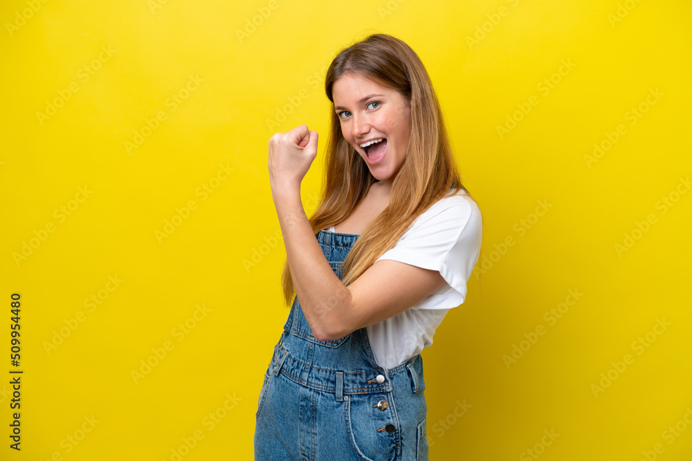 Young caucasian woman isolated on yellow background celebrating a victory Young caucasian woman isolated on yellow background celebrating a victory