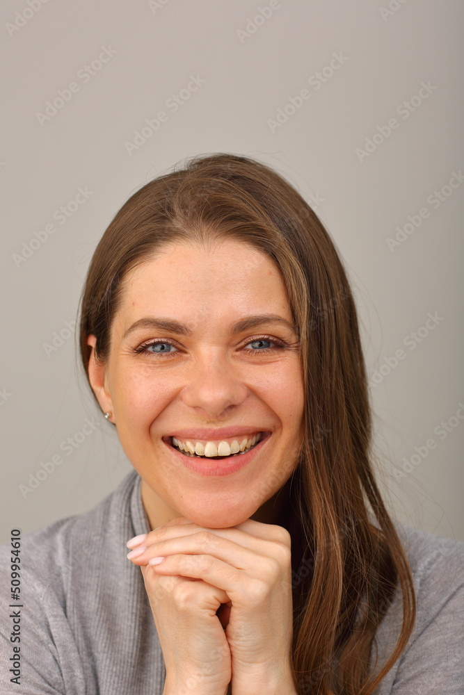 Smiling woman face portrait. Happy girl leaning on her hands with long hair isolated portrait Smiling woman face portrait. Happy girl leaning on her hands with long hair isolated portrait