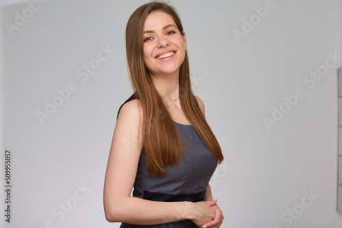 Business woman in gray business dress. Isolated portrait of smiling girl with long hair. © Yuriy Shevtsov