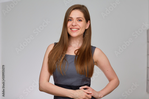 Business woman in gray business dress. Isolated portrait of smiling girl with long hair.