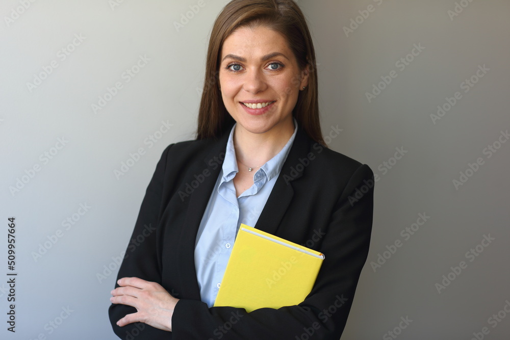 Woman teacher in black suit smile. student girl or business woman hold yellow book. Woman teacher in black suit smile. student girl or business woman hold yellow book.