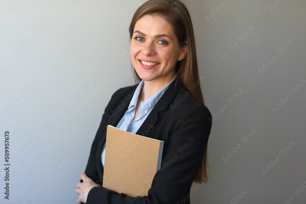 Teacher woman or girl student wearing black suit hold book , workbook and smile. Teacher woman or girl student wearing black suit hold book , workbook and smile.