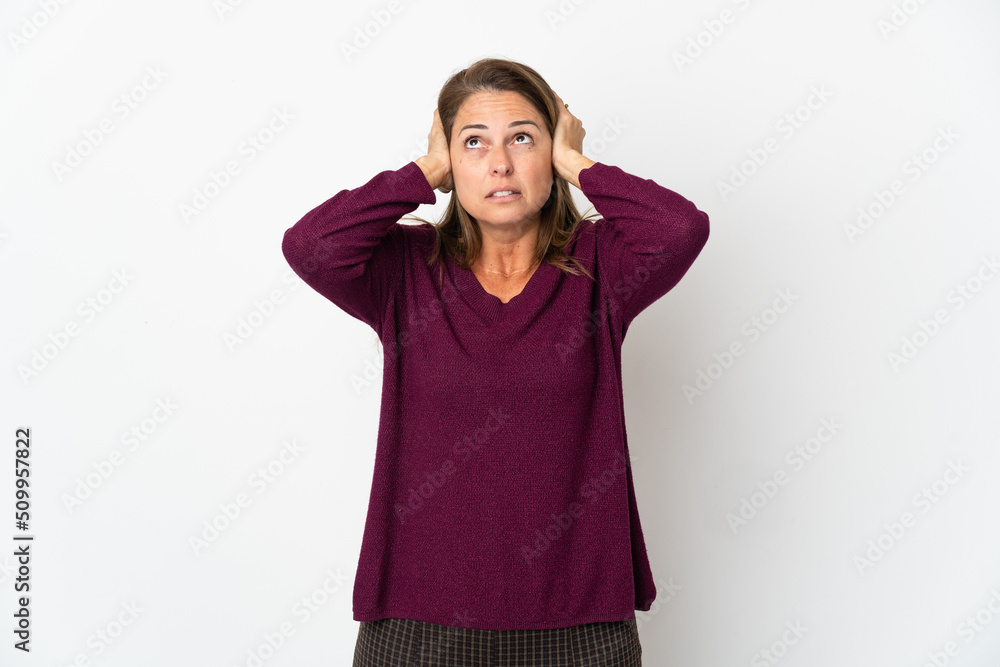 Middle age Brazilian woman isolated on white background frustrated and covering ears Middle age Brazilian woman isolated on white background frustrated and covering ears