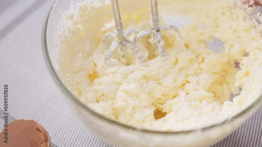 Preparing sweet food dessert in kitchen at home - mixing ingredients in bowl cooking dough Preparing sweet food dessert in kitchen at home - mixing ingredients in bowl cooking dough