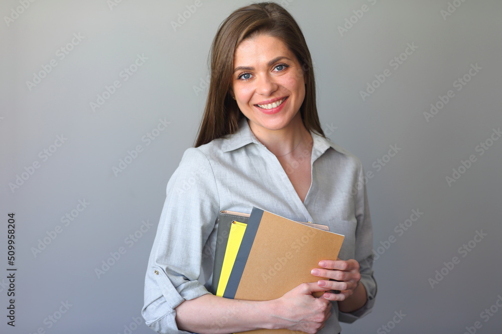 Smiling young woman teacher with work books. Smiling young woman teacher with work books.