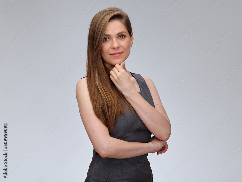 Smiling woman in gray dress touching her chin. isolated portrait. Smiling woman in gray dress touching her chin. isolated portrait.