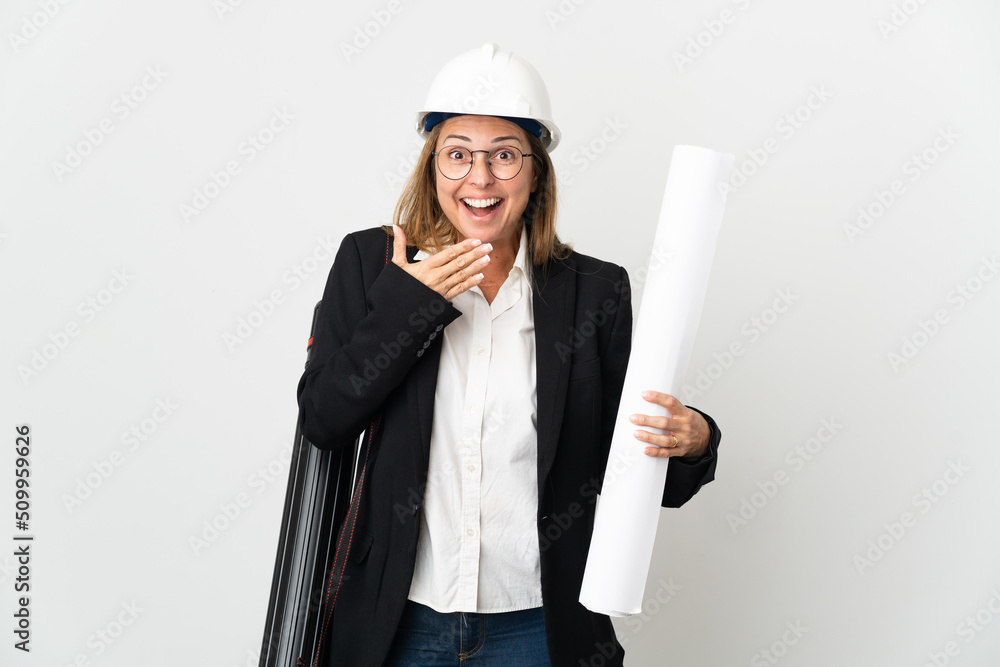 Middle age architect woman with helmet and holding blueprints over isolated background happy and smiling covering mouth with hand Middle age architect woman with helmet and holding blueprints over isolated background happy and smiling covering mouth with hand