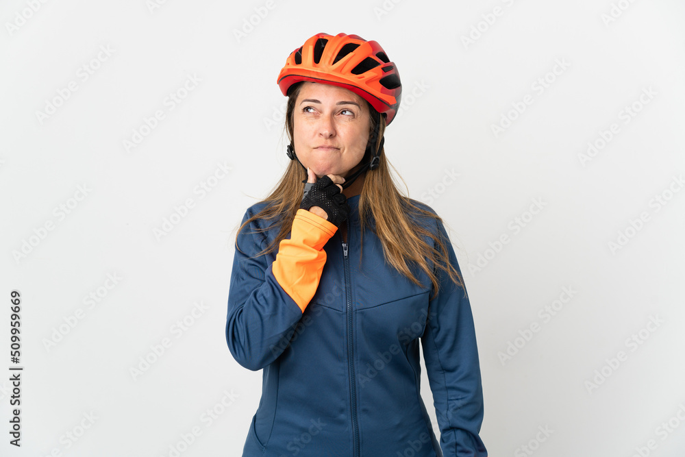 Middle age cyclist woman isolated on white background having doubts and thinking Middle age cyclist woman isolated on white background having doubts and thinking
