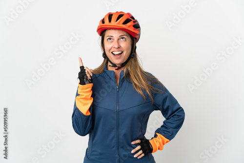 Middle age cyclist woman isolated on white background thinking an idea pointing the finger up