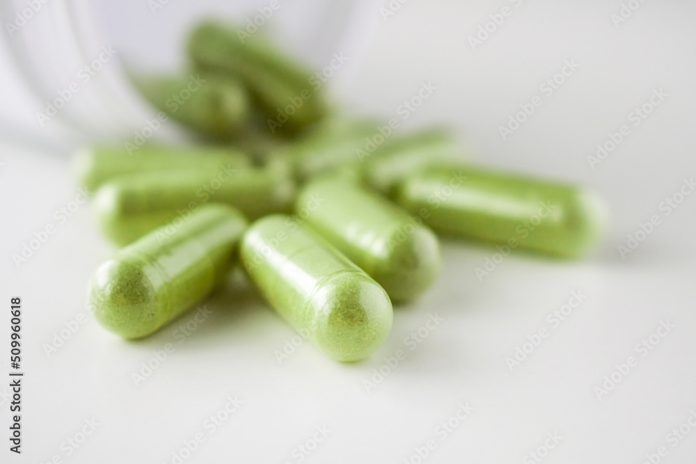 Herbal medicine capsules with bottle on white background Herbal medicine capsules with bottle on white background
